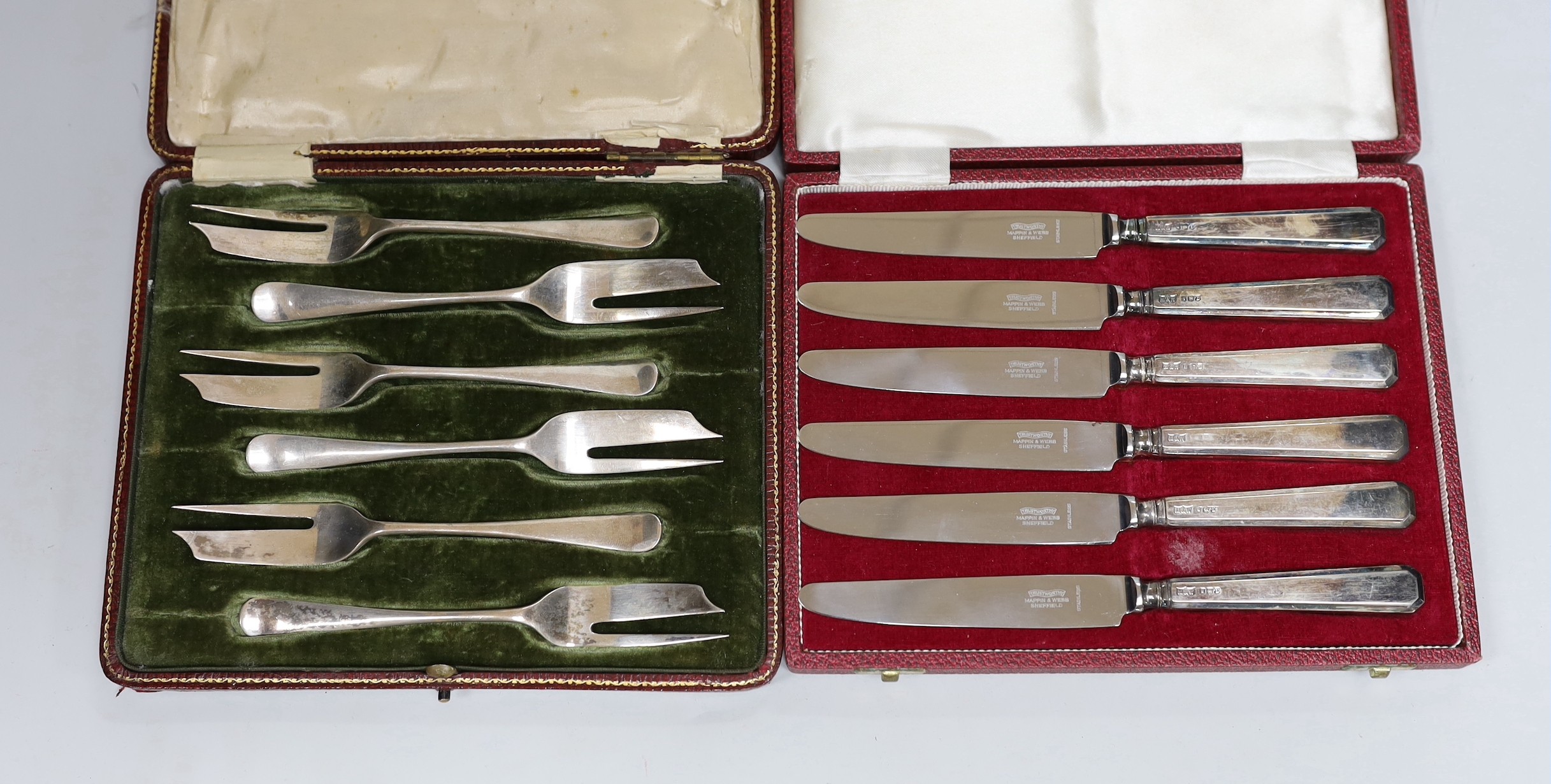 A cased set of Edwardian silver grape shears, Sheffield, 1901 and two other cased sets including cake forks and tea knives.